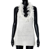 Minivestido de punto con espalda descubierta, borlas y cuello halter anudadas 