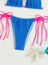 Traje de baño bikini texturizado con lazo en contraste y cuello halter 